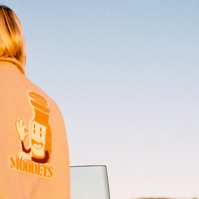 Crop of Moodeys Varsity jacket against blue sky