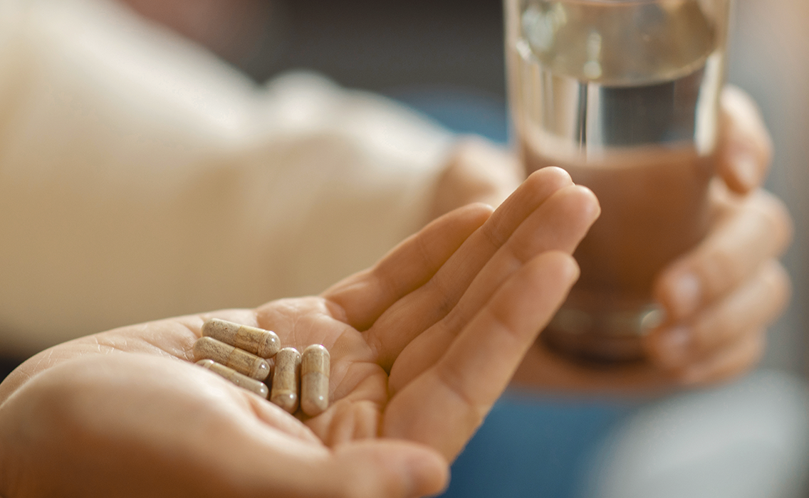 close-up-of-man-hands-holding-medication-and-glass-2024-05-02-18-14-23-utc.png